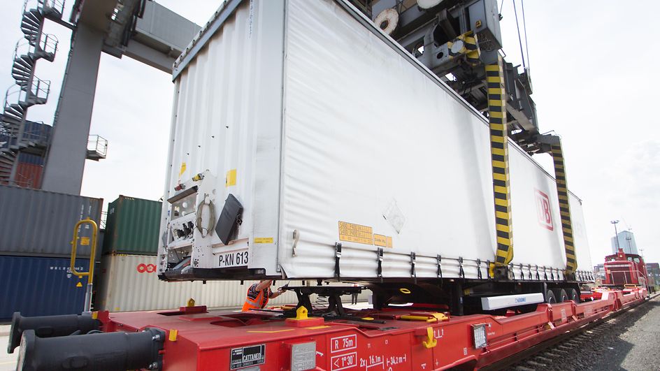 Semi-trailer gets loaded onto a wagon