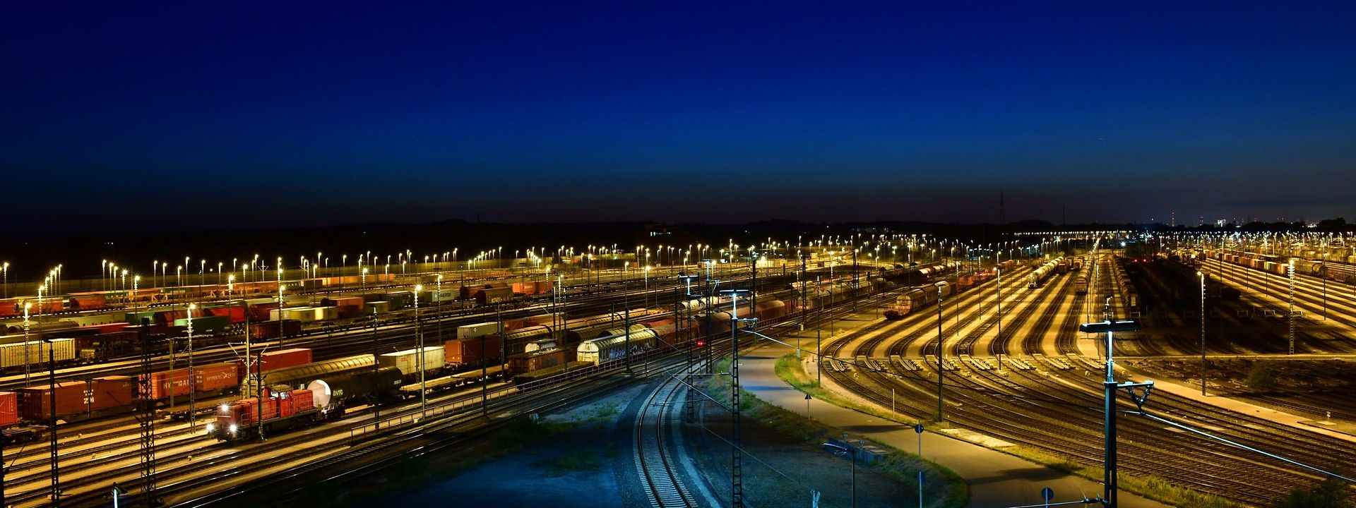 An illuminated track field at dusk